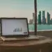 showing performance report while sky line of doha is behind